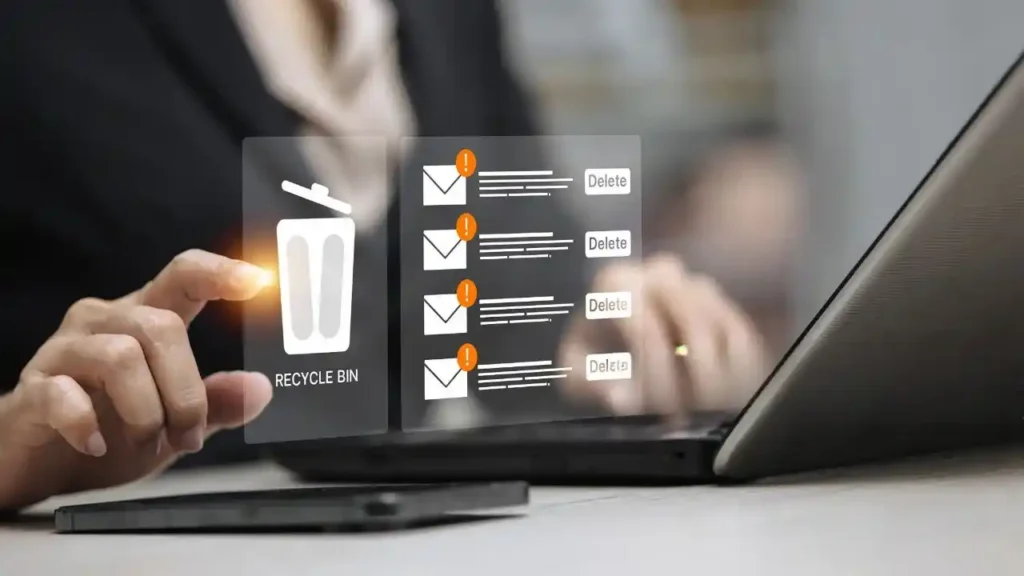 Person using a laptop to delete unwanted emails and digital files, helping free up storage space and keep the computer organised.