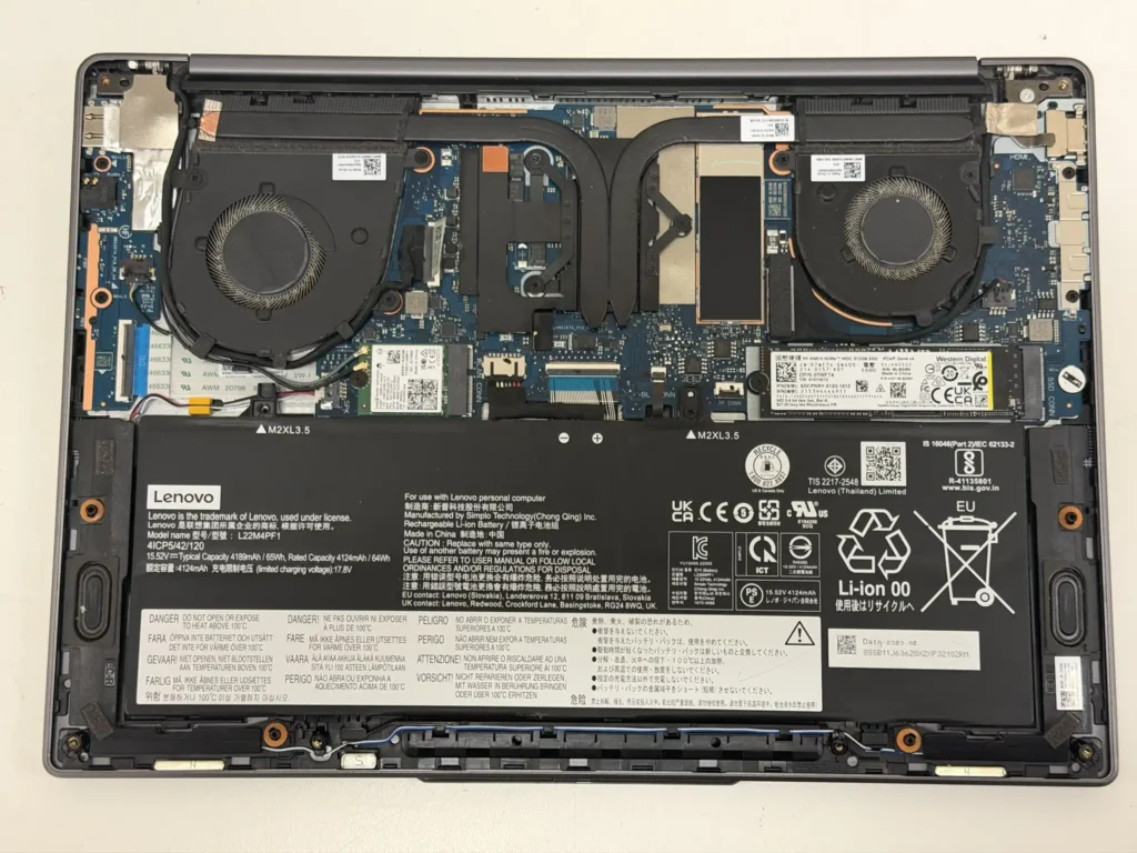 Internal hardware components of a Lenovo laptop after fan cleaning and Western Digital NVMe SSD installation.