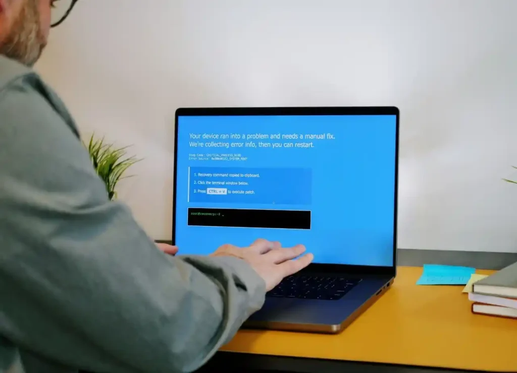 Laptop displaying a Windows error screen before login, illustrating a system problem that can cause a black screen during startup.